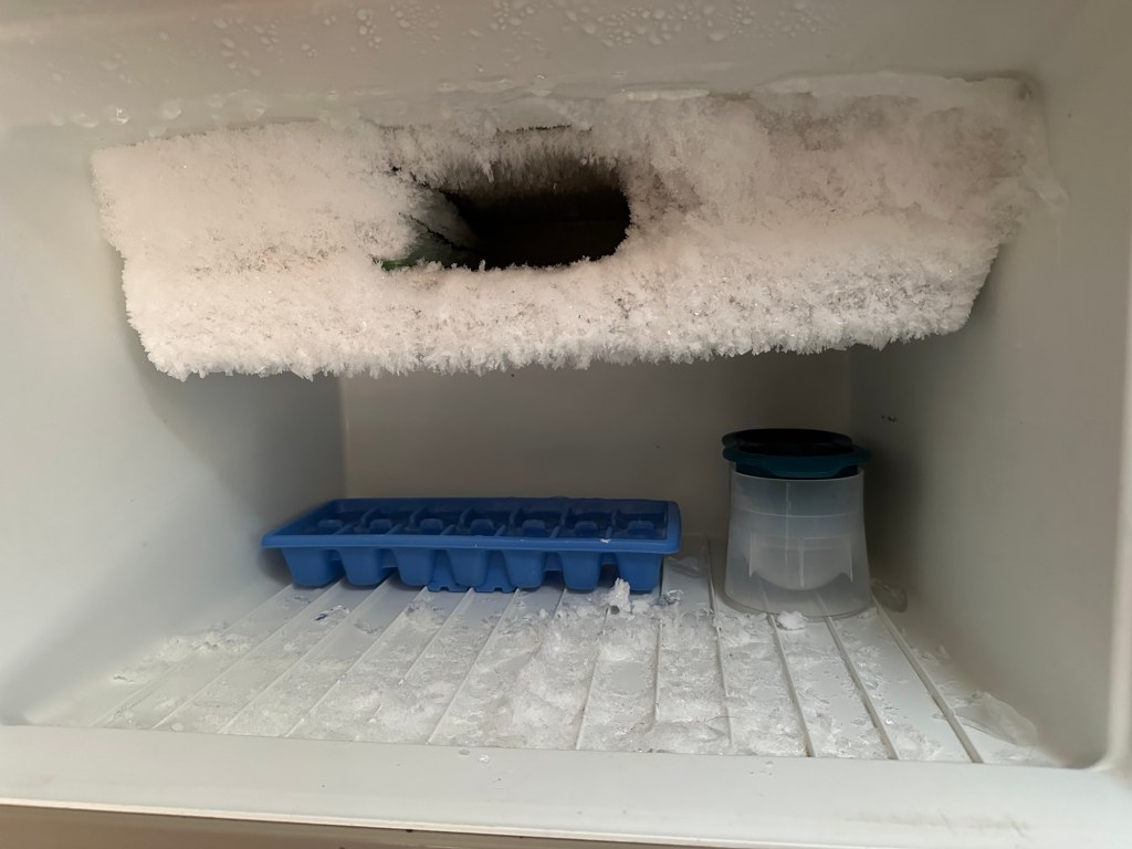 Over-frozen freezer in an old trailer, filled with ice and a single tray of cubes—one power outage away from the Titanic.